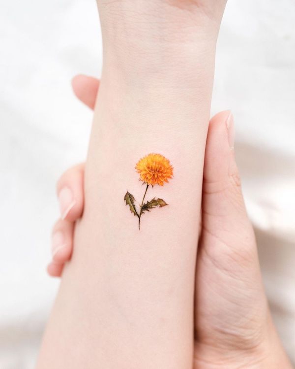 Small yellow dandelion wrist tattoo by @donghwa_tattoo