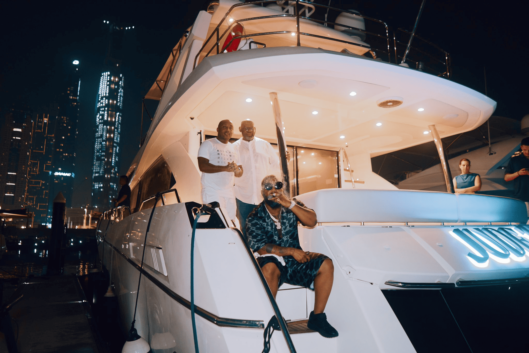 Cassper Nyovest smoking a cigar on a yatch.