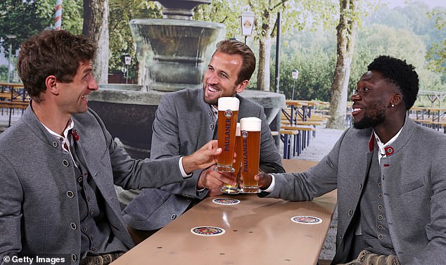 Bayern Munich's superstar striker Harry Kane, alongside teammates Thomas Muller and Alphonso Davies, posed during a photoshoot with Bayern's partner Paulaner wearing traditional lederhosen