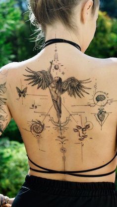 This may contain: the back of a woman's neck with tattoos on her body and various symbols