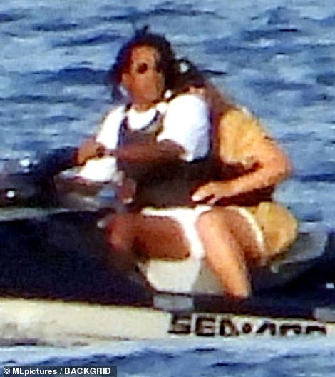 Hold on: Beyoncé kept a tight grip on her husband's waist during their jet-ski ride