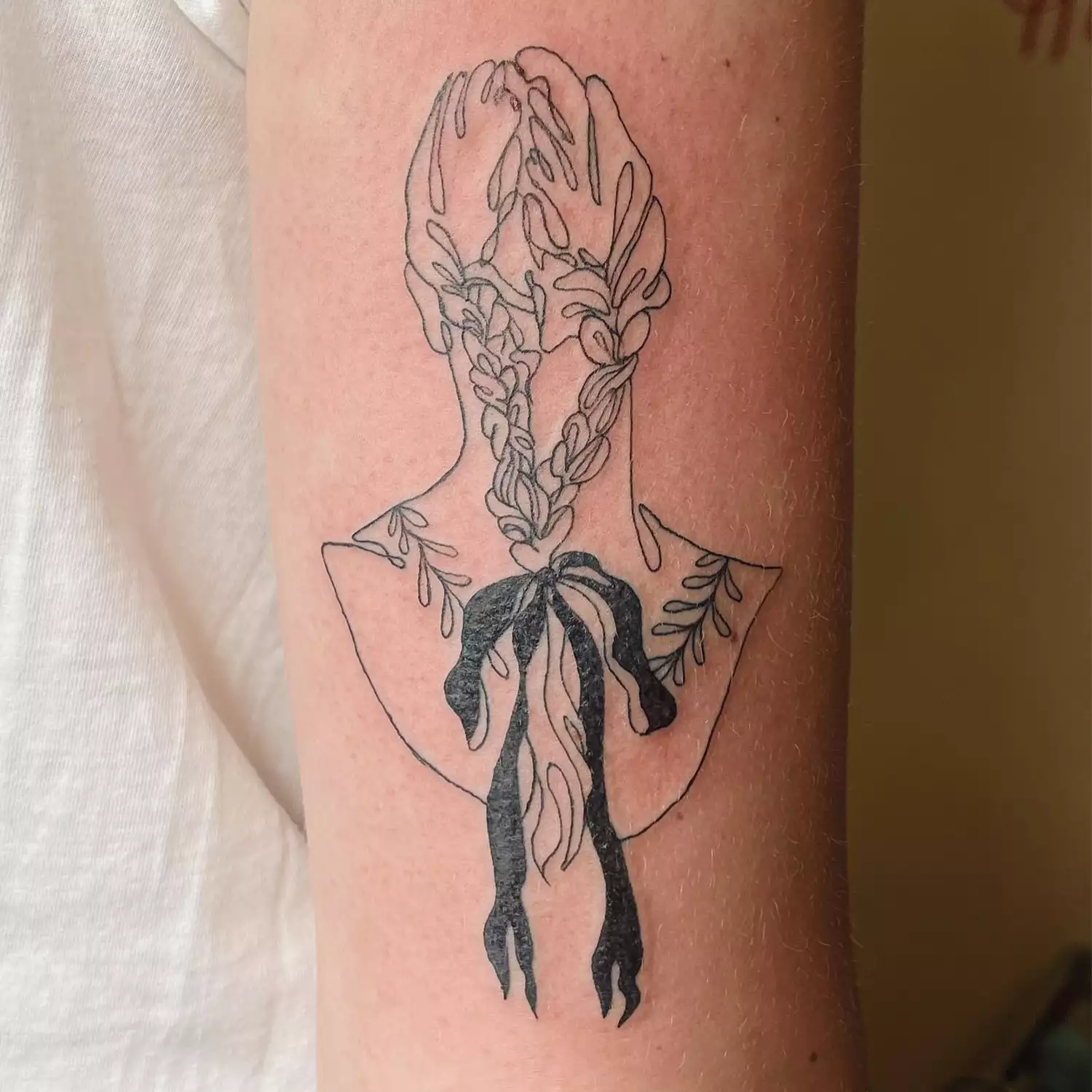 Tattoo of a bust with a bow 