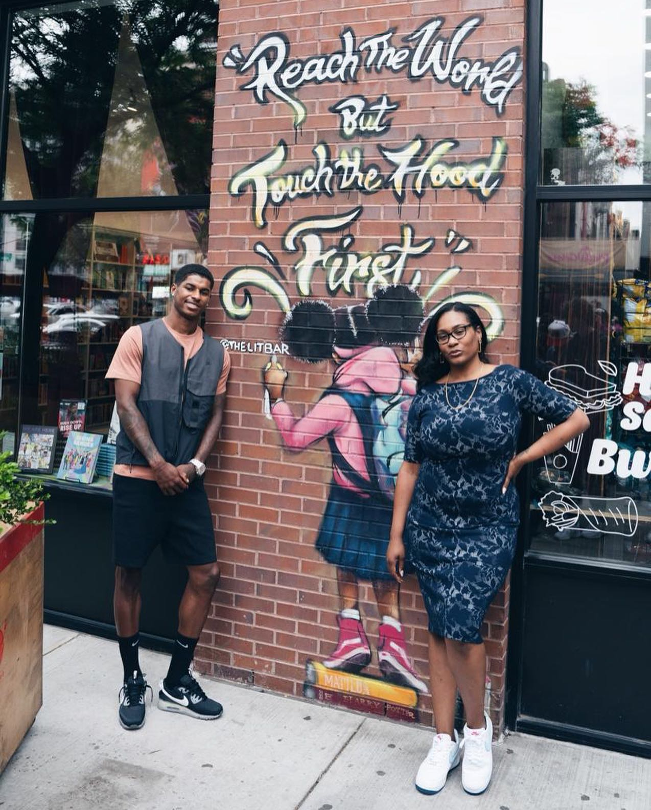 Rashford poses next to a mural at The Lit Bar