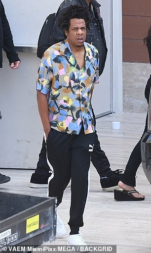 Designer: Jay Z opted for a casual smart look in a patterned Dior shirt and black Puma track-pants