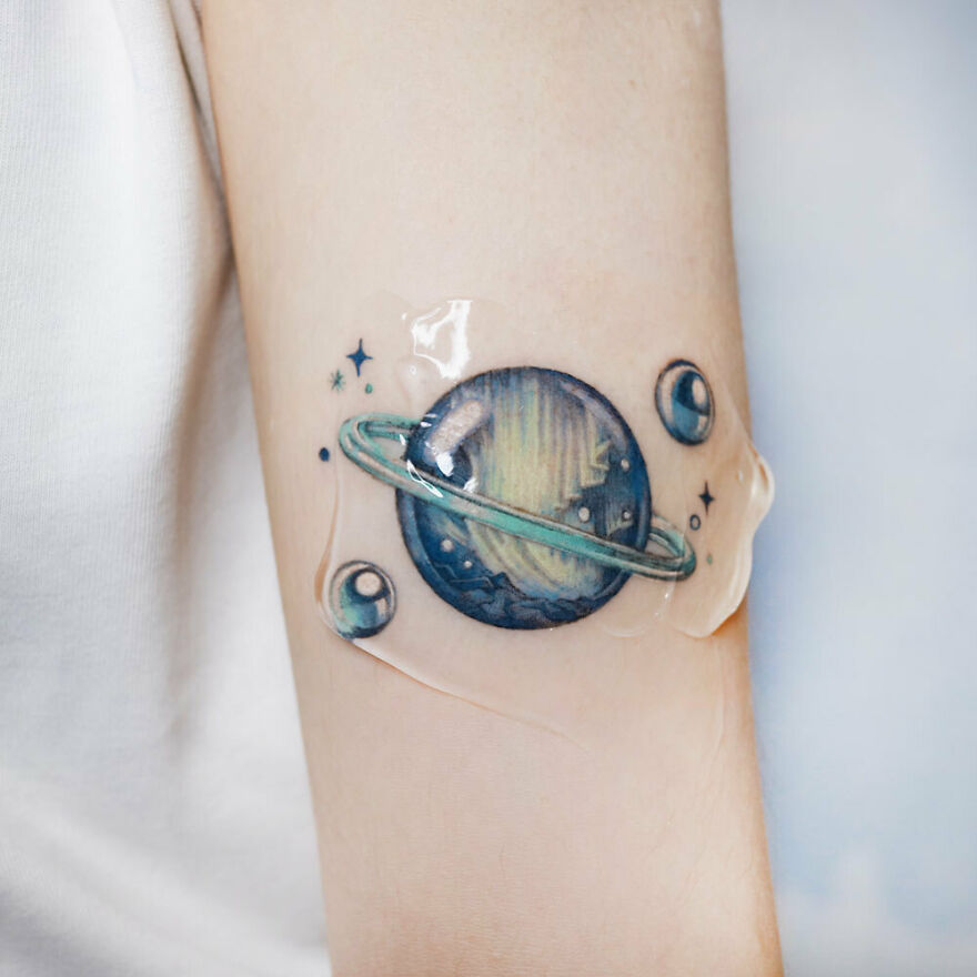 Saturn and soap bubbles arm tattoo 