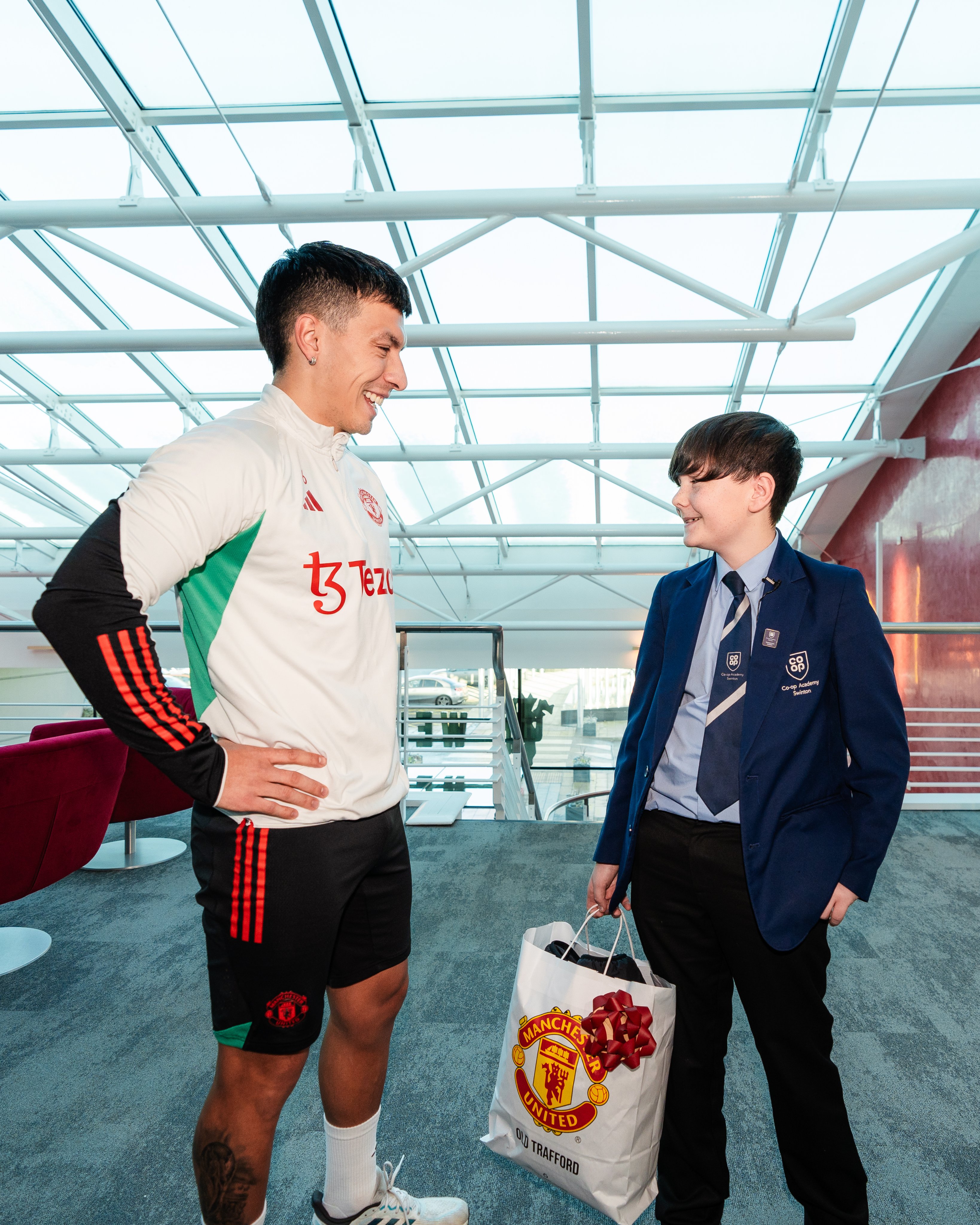 Lisandro Martinez chats with partner school pupil Archie.