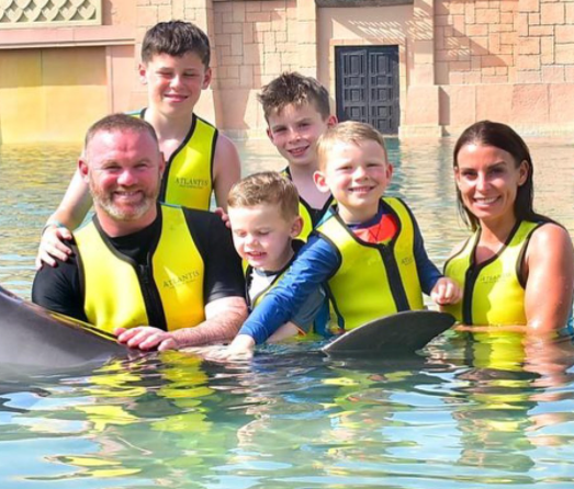 Coleen posted pictured of the family swimming with dolphins