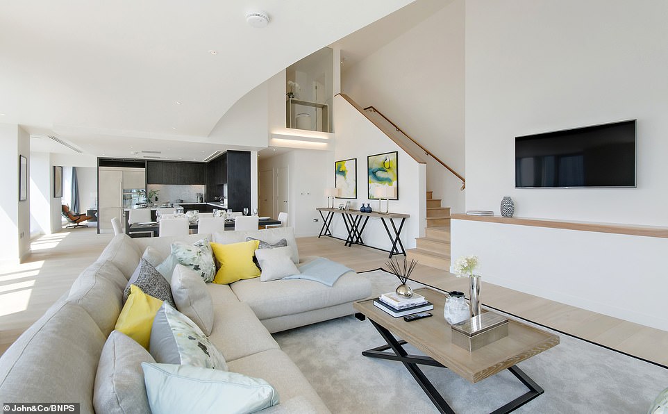 Pictured: The sprawling living and open-plan dining area in the penthouse flat in East India Dock, Tower Hamlets. It is now on the market for less than £2million and sits on the 25th and 26th floors of the Ontario Tower apartment complex in East London