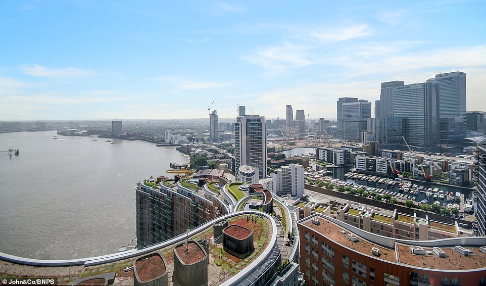 The penthouse flat looks over Canary Wharf and the Isle of Dogs to the east and the lucky buyer would enjoy sweeping views of the Thames from the 25th and 26th floor of Ontario Tower in East London, with the building formerly housing Patrice Evra, Andy Carroll and Jose Fonte