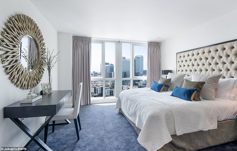 The lavish penthouse boasts three bedrooms in total and takes in sweeping views of the Thames from its vantage points on the 25th and 26th floors