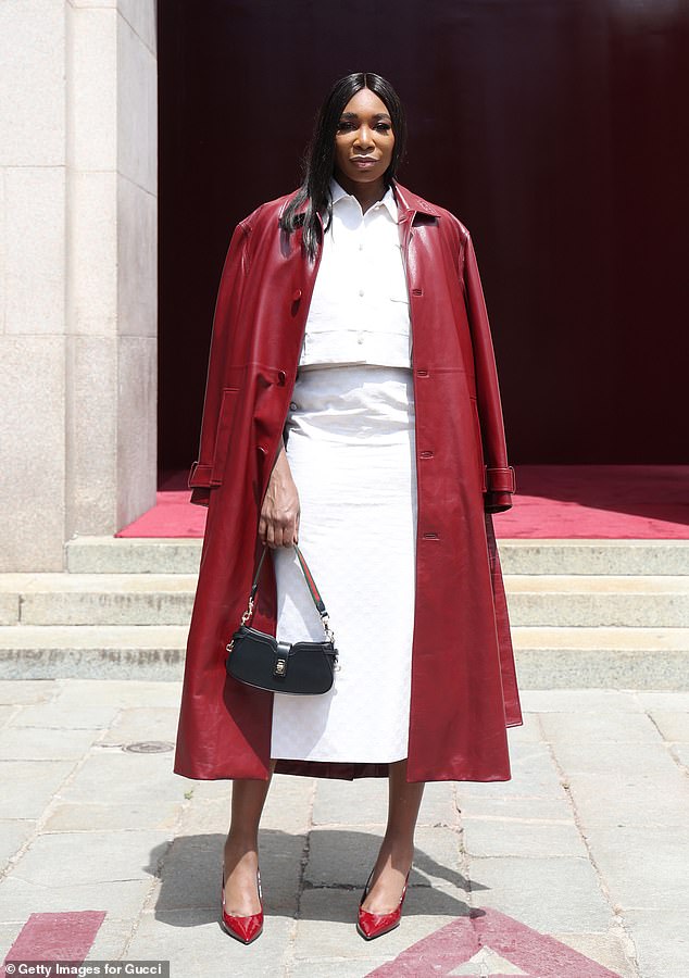 Venus, 44, turned heads in a cropped white blouse which she teamed with a matching fitted midi-skirt and a stylish burgundy leather trench