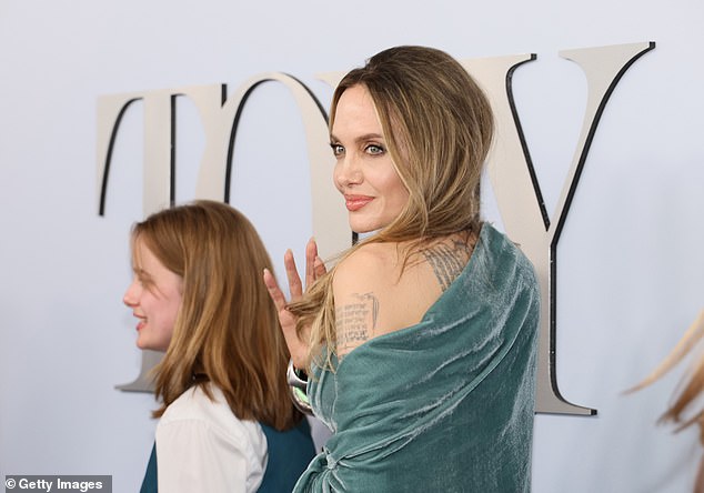 At one point, Angelina slightly turned away from the camera to flash a glimpse of some of her tattoos on her left arm and upper back