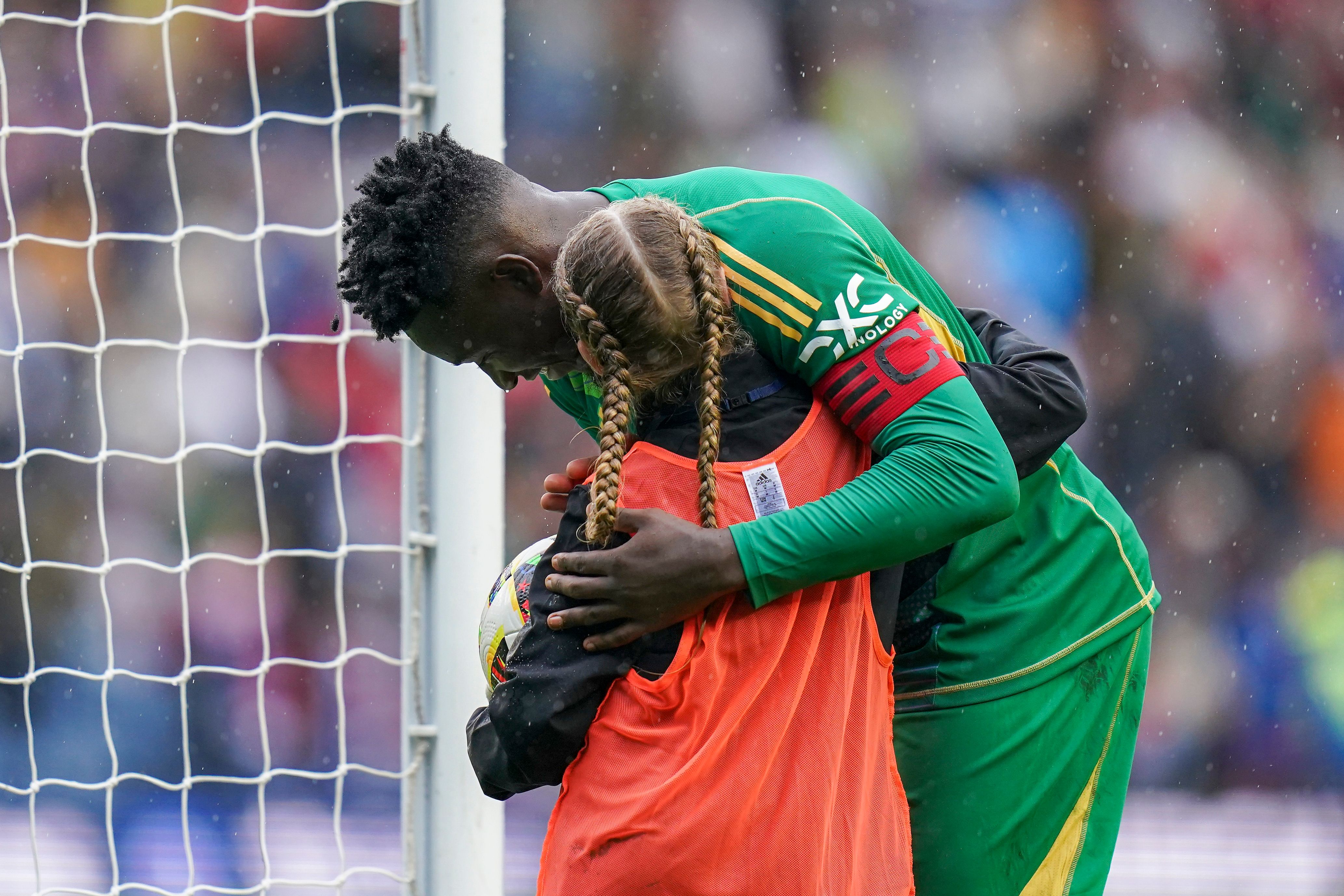 Onana gave the child a hug before he handed her a stunning gift