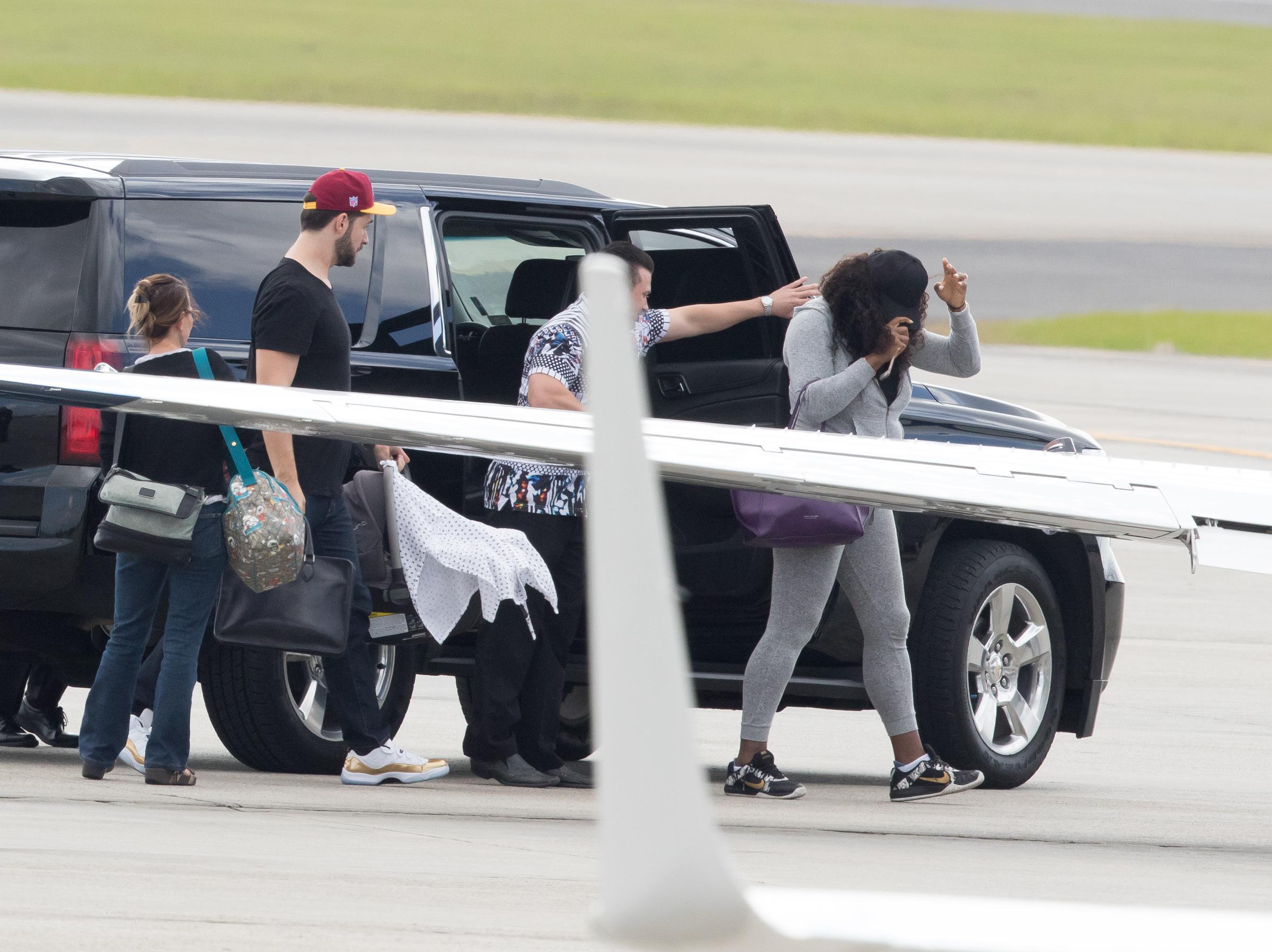  The newly-weds kept a low profile on the tarmac as they left New Orleans