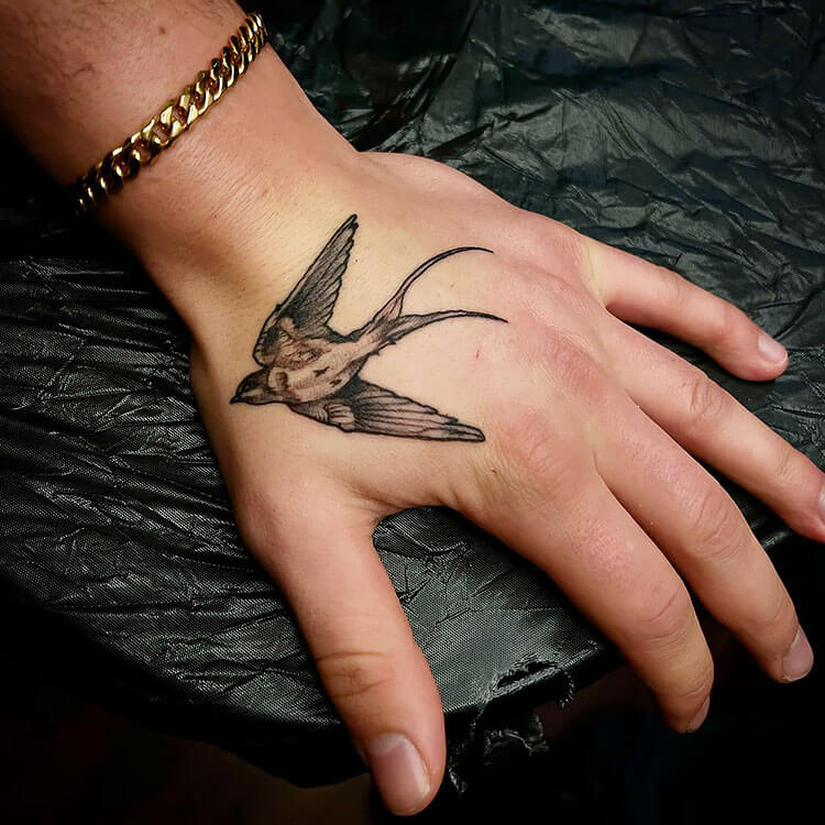 swallow bird hand tattoo