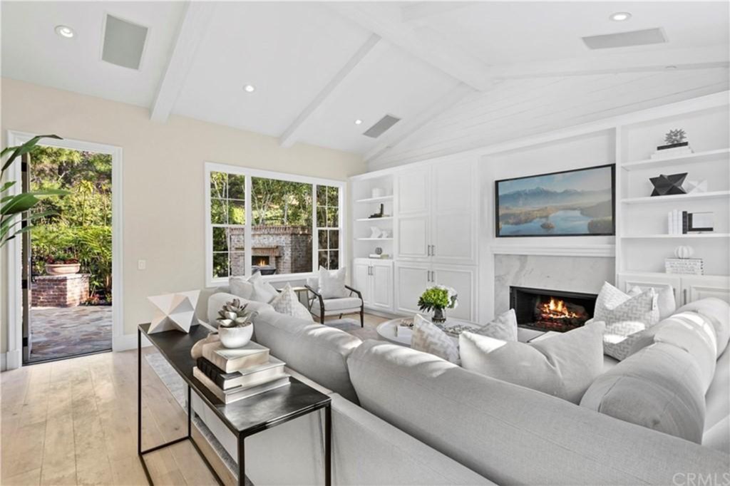 The open-floor living room drenched in sunlight. 