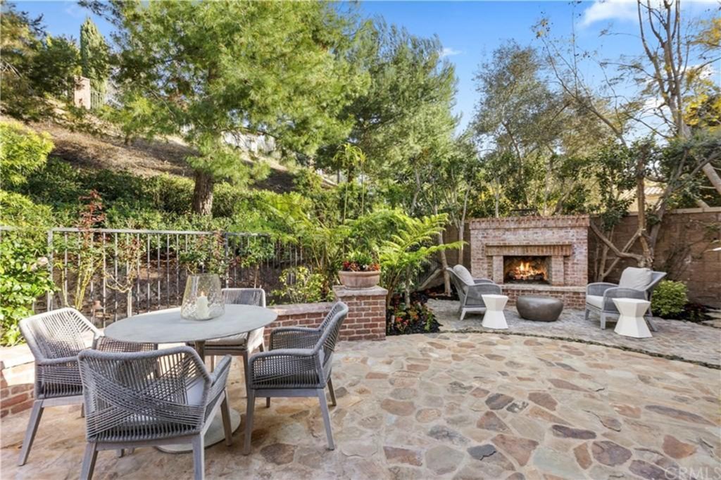 The outdoor patio features a fireplace and BBQ with plenty of space for entertainment. 