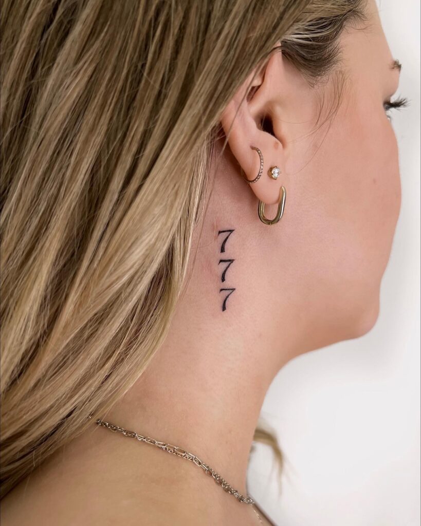 Vertical number tattoo on the side neck, women's black ink elegance "777" angelic alignment
