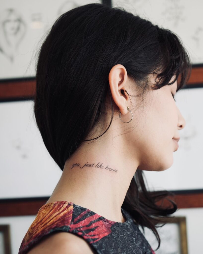 Heavenly elegance word tattoo on the side of a girls neck
